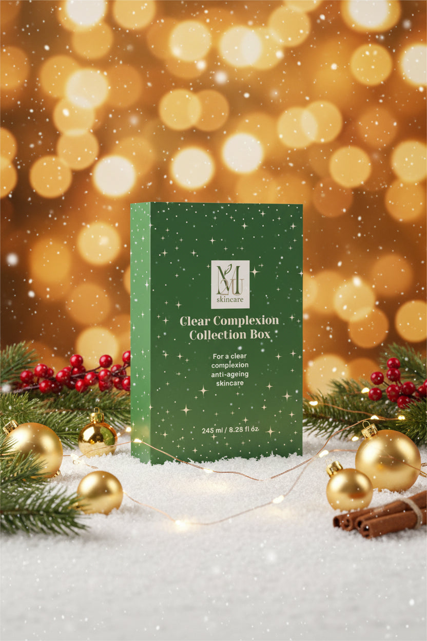 A tall rectangular green skincare collection box with white star-like speckles and white text reading 'Clear Complexion Collection Box' and a visible 'M skincare' logo, photographed on a clean light gray studio background.
