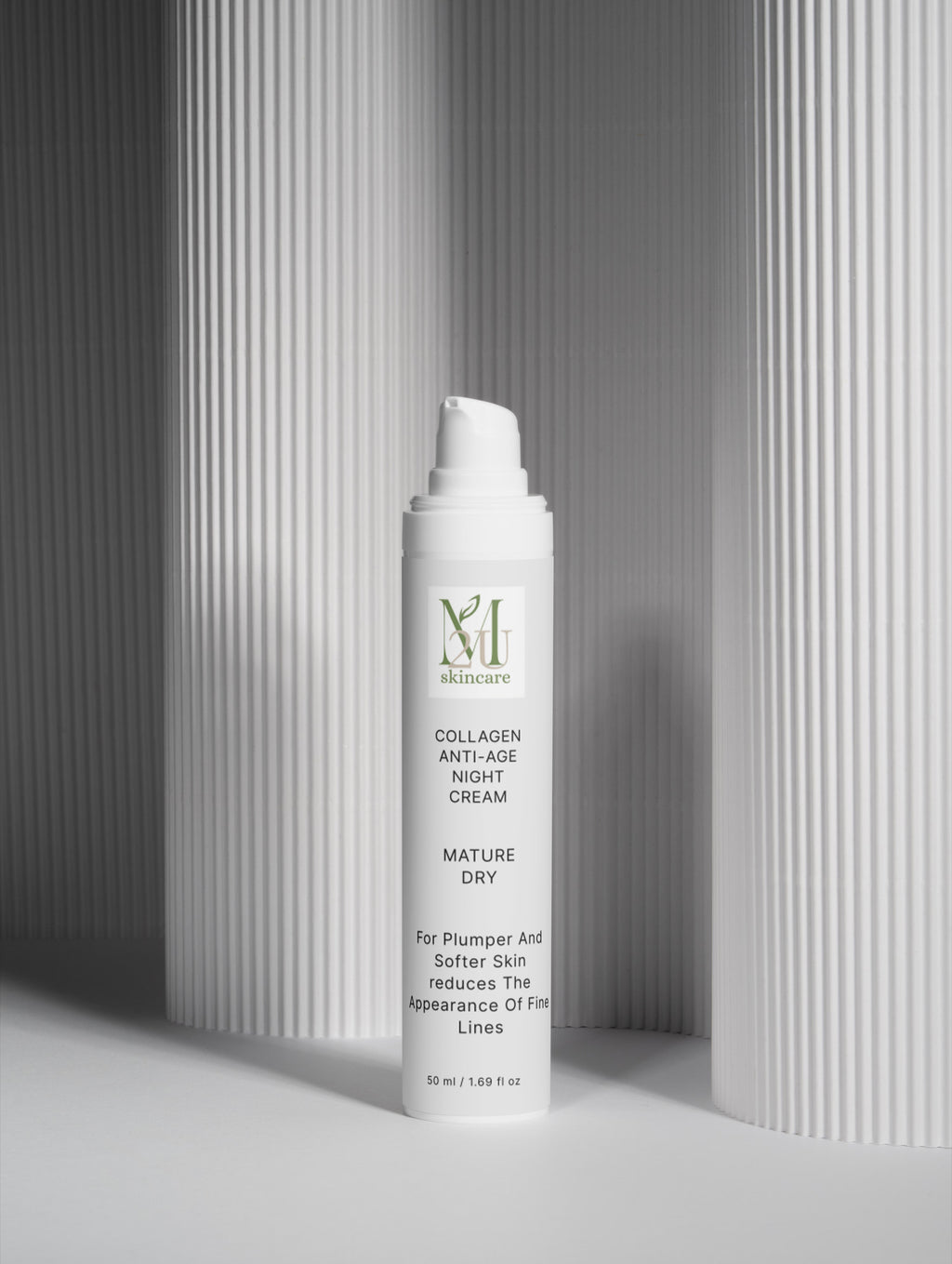 A white pump bottle of MHA Skincare Collagen Anti-Age Night Cream standing upright on a light gray surface, with a gray ribbed background and soft shadows.