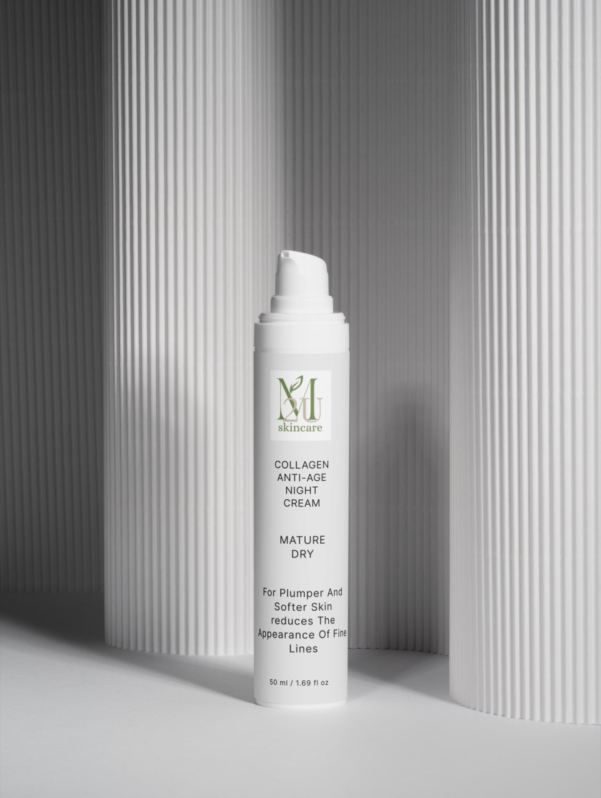 A white pump bottle of MHA Skincare Collagen Anti-Age Night Cream standing upright on a light gray surface, with a gray ribbed background and soft shadows.